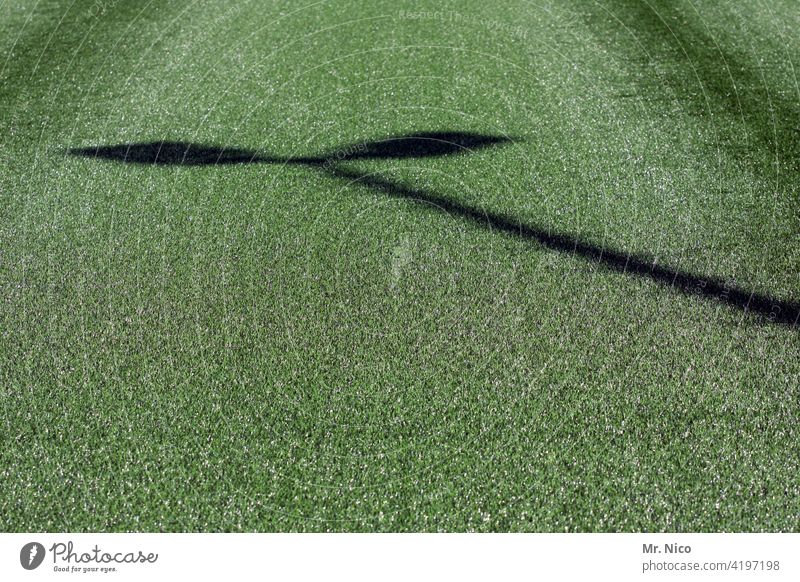 Shadow of a floodlight pole on artificial turf Artificial lawn artificial turf pitch Green Football pitch Sports Sporting Complex Leisure and hobbies Floodlight