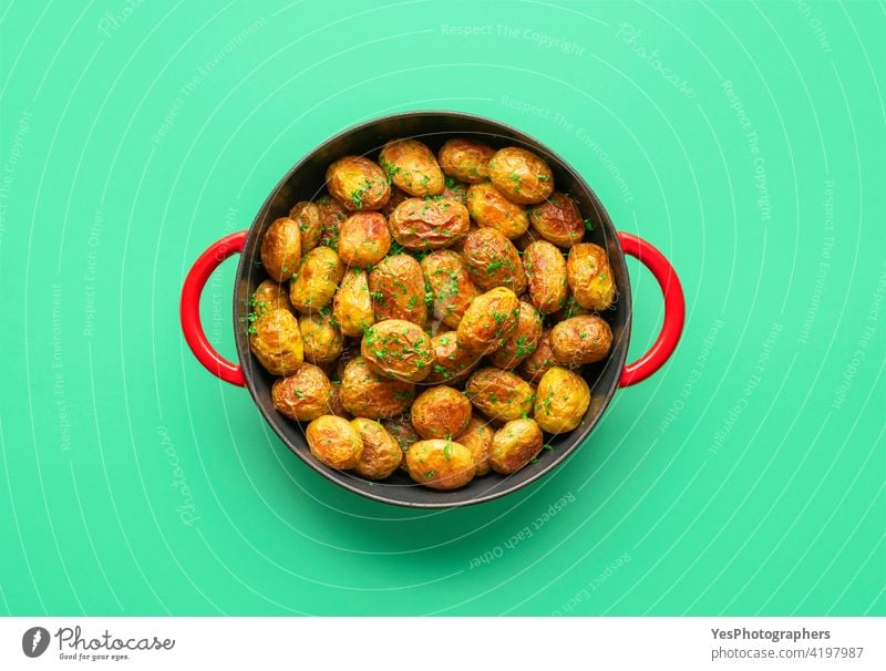 Roasted baby potatoes in a pan, top view on a green background. above appetizer baked color copy space cuisine cut out delicious dill dinner dish flat lay food