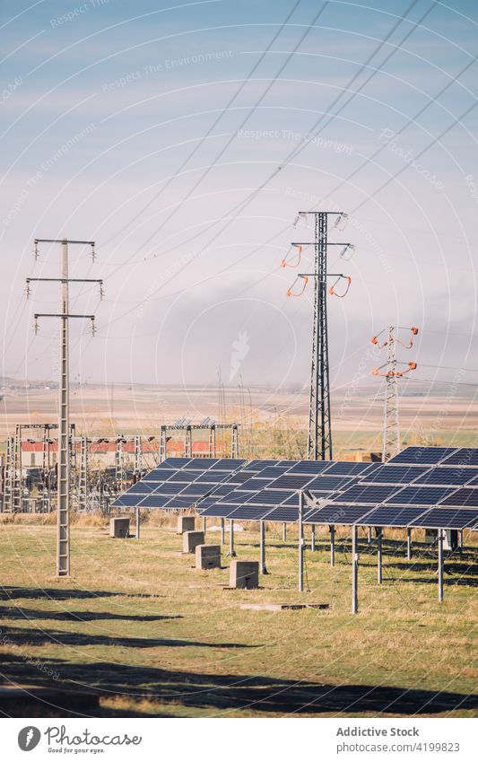 Solar panels against cloudy sky solar power station reflecting photovoltaic cloudless sunny field cells daytime energy electricity technology shiny weather