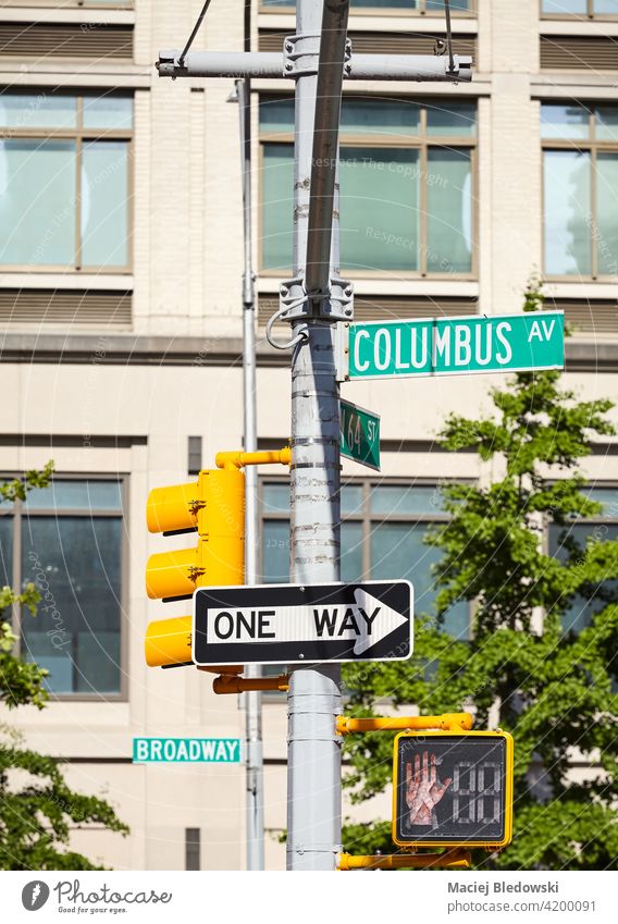 Columbus Avenue and One Way street signs in New York City, selective focus with building in background, USA. traffic one way road sign city Manhattan transport