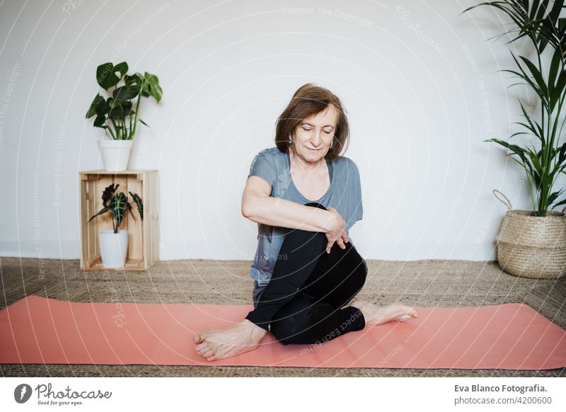 mature caucasian senior woman practicing yoga pose at home. Healthy lifestyle sport healthy floor old active pensioner gym elderly female exercise age smile