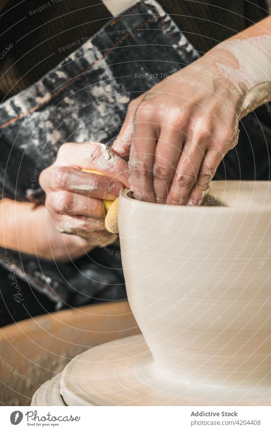 Unrecognizable female ceramist making clay bowl in studio pottery wheel craftswoman create clayware workshop earthenware artisan ceramic handmade handicraft