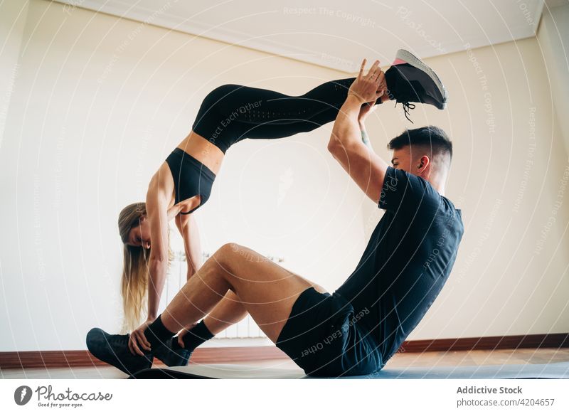 Man and Woman in Black Sport Clothes Doing Acroyoga on a Sea Beach. Woman  Lying on Male Feet. Healthy Lifestyle, Yoga Lovers Stock Photo - Image of  nature, beach: 232254856