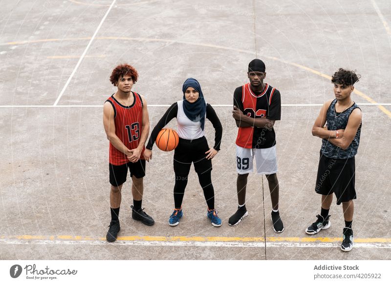 Multiethnic streetball team on sports ground basketball together court confident unity multiethnic multiracial diverse black african american muslim athlete