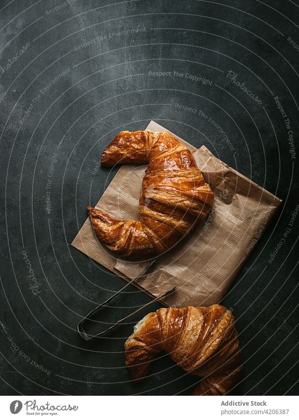Delicious croissants with paper bag baked bread food fresh tong bakery bun pastry breakfast shape cuisine nutrition crust rustic culinary delicious product meal