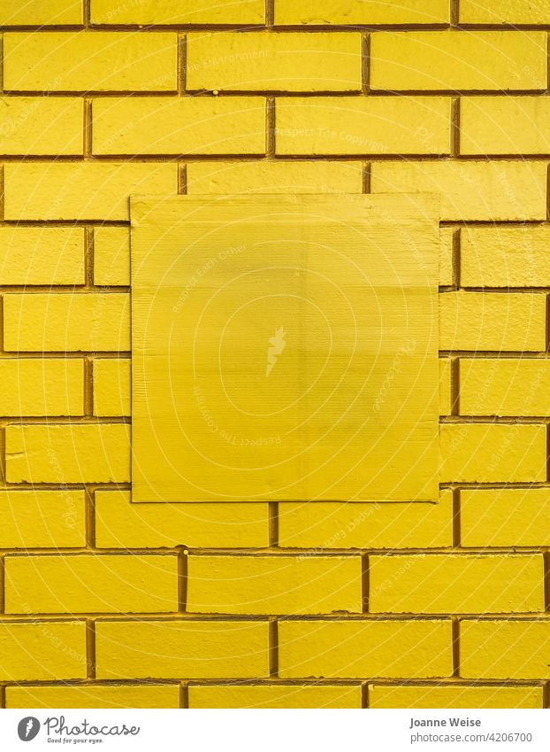 Yellow brick wall with central square blank space. yellow background Brick wall Wall (building) yellow wall Copy Space middle Colour photo Structures and shapes