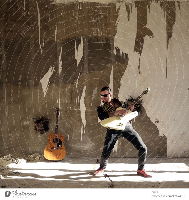 Stringmaster Full-length portrait Masculine Man Music Artist Guitar Musician Wall (barrier) Wall (building) Jacket Sunglasses lost places Ruin Stand Playing