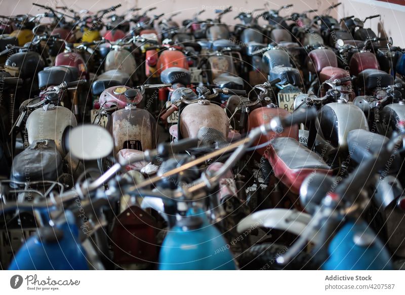 Rows of motorbikes in repair workshop motorcycle old fashioned damage many garage weathered rust service maintenance grunge metal aged retro broken vehicle