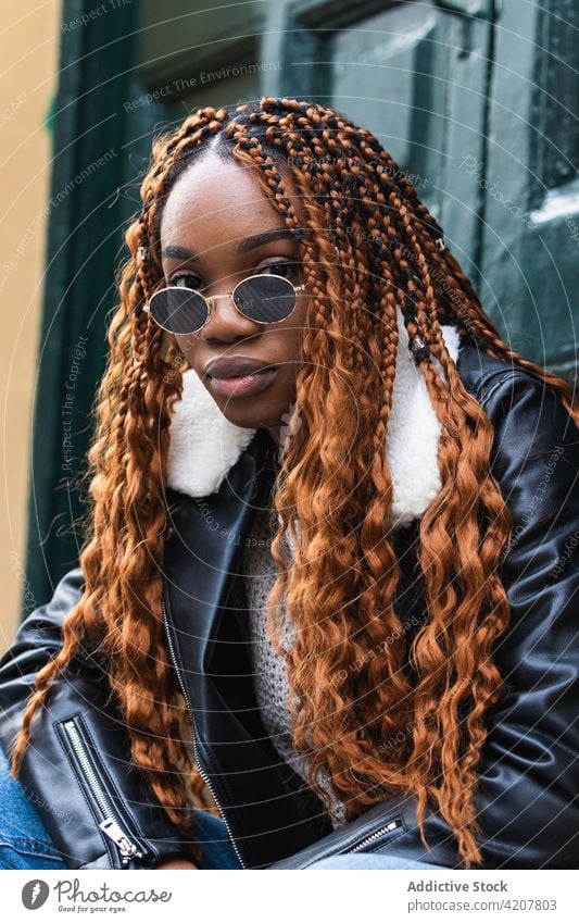 Stylish black woman with sunglasses looking at camera cool style street cover face confident trendy braid hairstyle outfit female ethnic african american urban
