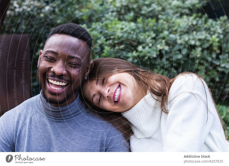 Cheerful multiethnic couple resting in park love romantic together multiracial cheerful relationship affection happy close young diverse african american black