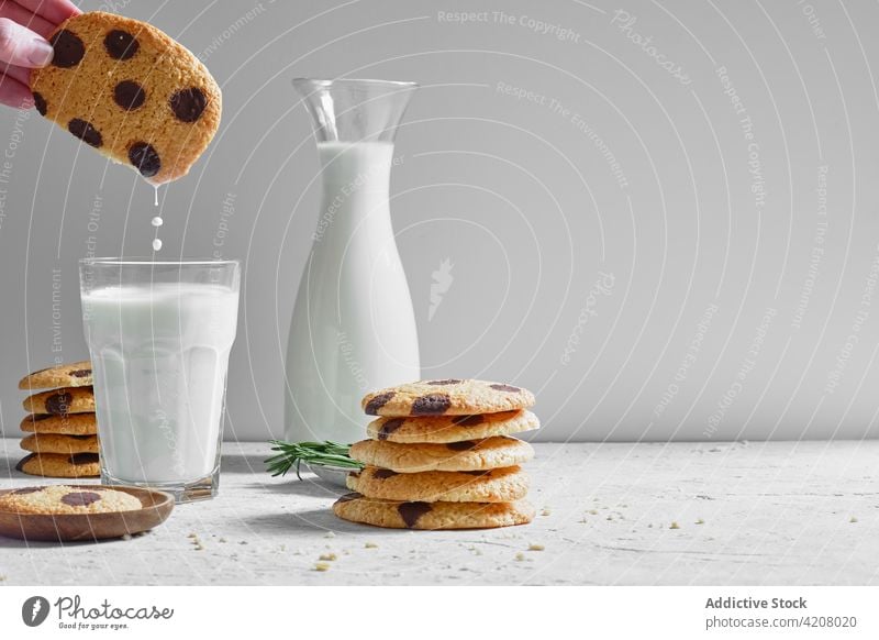 Person dipping cookie into milk chocolate food sweet homemade pastry eat drink drop baked glass person dessert delicious yummy treat appetizing fresh meal