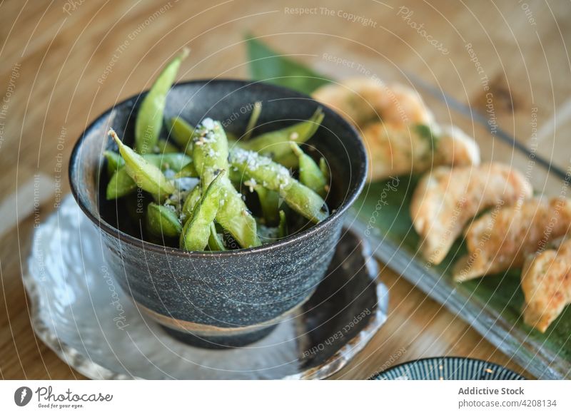 Sushi Plate and Soya Beans Snack edamames fresh delicious green appetizer vegetable vegan bean oriental salt soybean sushi top view yummy meal restaurant gyozas