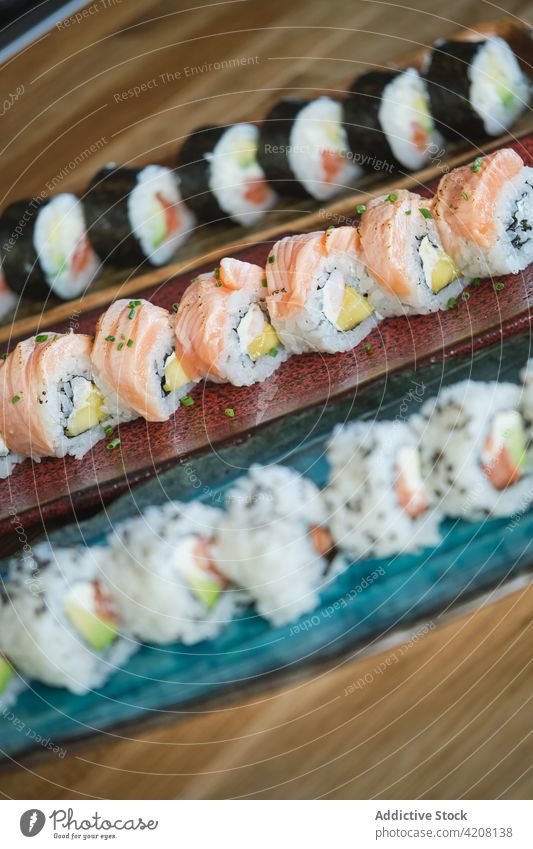 Delicious Sushi Plates in Restaurant front view plates variety japanese restaurant sushi sushi plates many healthy seeds rice japanese food salmon seafood