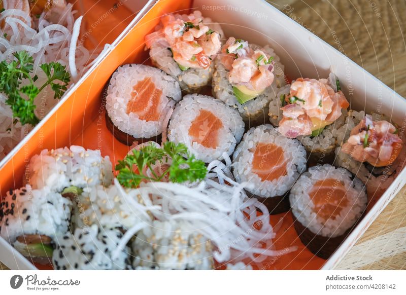 Detail of Box with Varied Sushi top view sushi rice salmon seaweed fish seafood japonese food variety many delicious yummy japanese food nagiri rolls macro