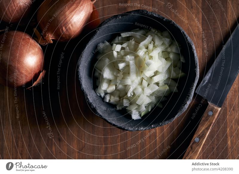Bowl with chopped onion on table bowl cook kitchen ingredient organic lumber knife rustic cut timber cuisine fresh food healthy dish prepare vegetable culinary