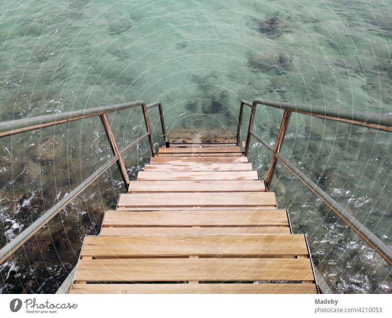 Bathing steps in sunshine with clear water in the bay of Alacati near Cesme at the Aegean Sea in the province Izmir in Turkey swimming ladder Bathroom stairs