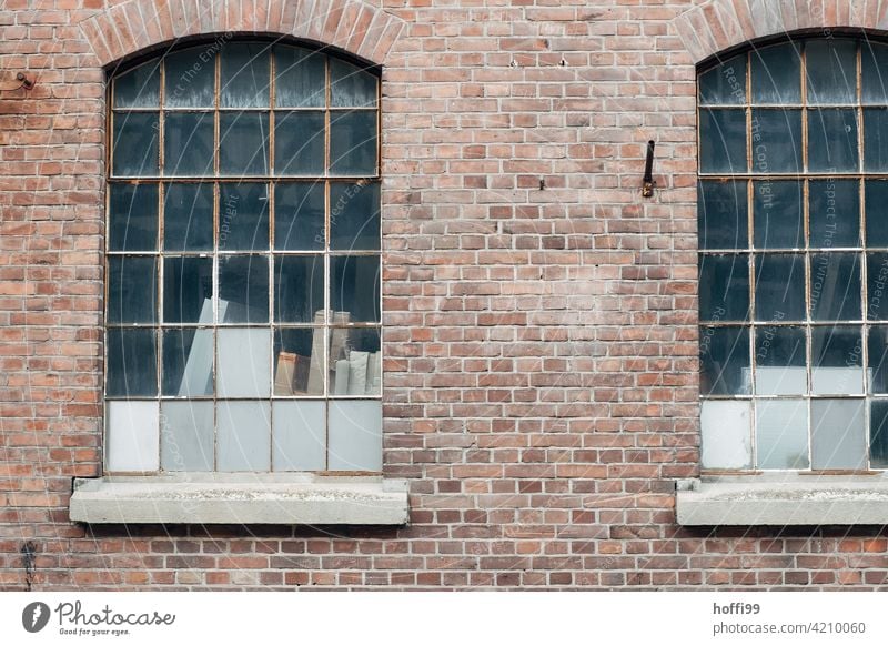 Two windows of a warehouse with red clinker and closed windows Warehouse Gloomy waiting zone 50s Harbour Logistics logistics Hall Flake Storage Industry
