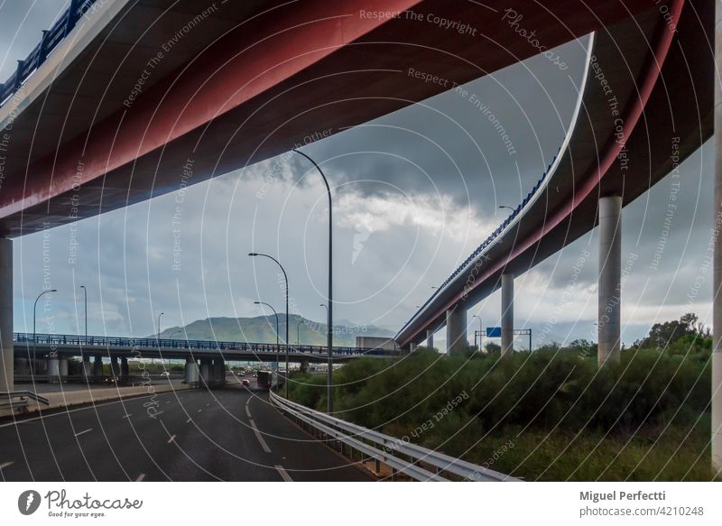 Several bridges at a highway junction with a cloudy sky. road architecture malaga infrastructures viaduct transportation overpass travel traffic city concrete