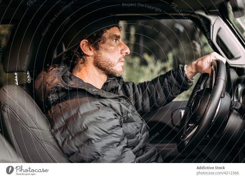 Side view of a man driving a car transportation people sitting beard adult car interior journey road trip travel drive copy space sunlight adventure off road