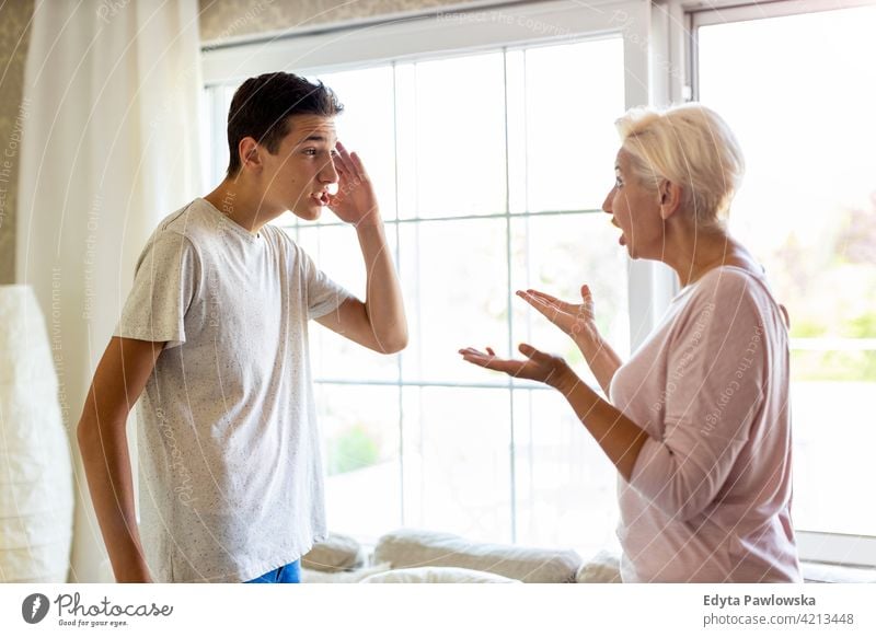 Mother and her teenage son arguing at home upset argue angry problem teenager mother conflict serious attitude child boy frustrated resentful stress frustration
