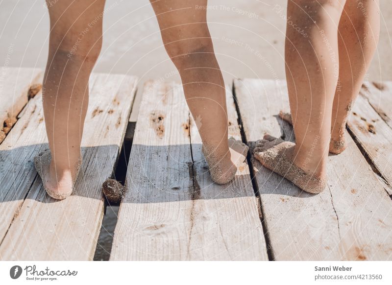 Children standing on the jetty by the sea children Infancy Playing Family Happy Joy Colour photo Exterior shot Happiness Nature Together Beach Footbridge Water