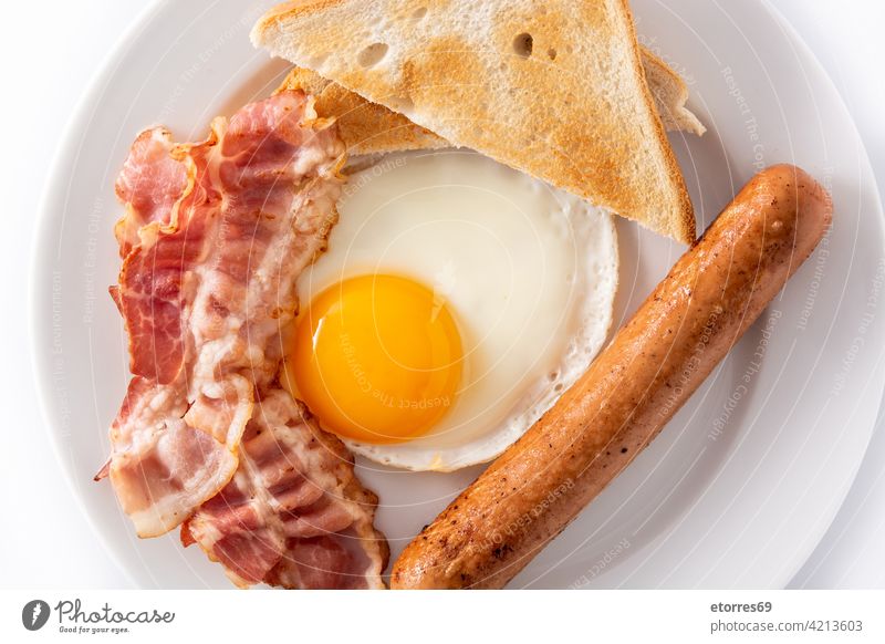 Traditional American breakfast with fried egg,toast,bacon and sausage american bread brunch continental dish fat food full isolated meat menu nutrition plate