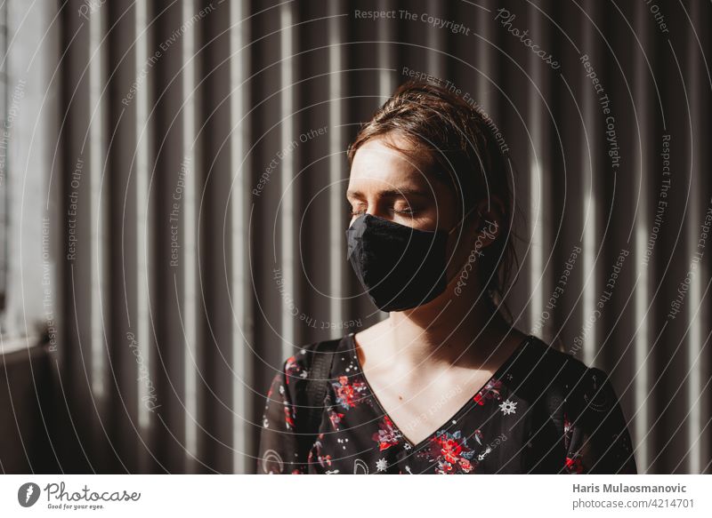 depressed pale woman with face mask and closed eyes on the sun adult american anxiety apocalyptic black breathe caucasian color concept coronavirus covid 19