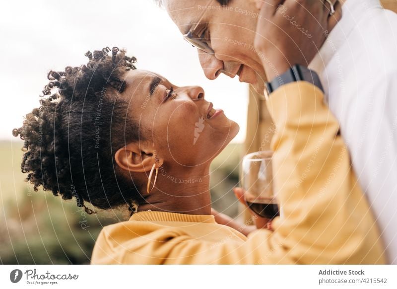 Multiracial loving couple looking at each other in nature love relationship in love cheerful stare romantic happy together multiethnic multiracial diverse black