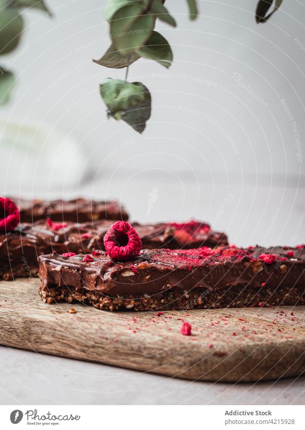 Several chocolate bars with raspberry on a table dessert sweet food snack cocoa tasty brown delicious isolated candy piece dark cacao milk calorie ingredient