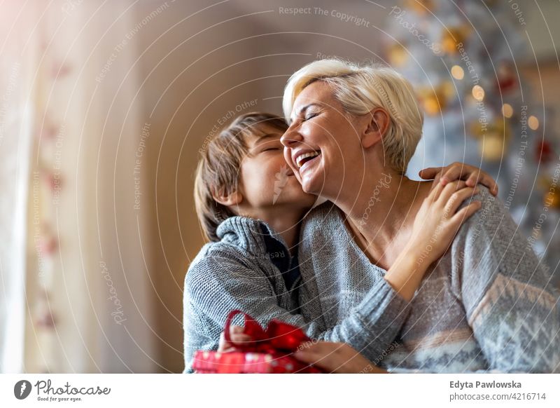 Merry Christmas And Happy Holidays! Senior Mom, Dad And Their Adult Daughter  Exchanging Gifts. Having Fun Near Tree Indoors. Loving Family With Presents  In Room. Stock Photo, Picture and Royalty Free Image.