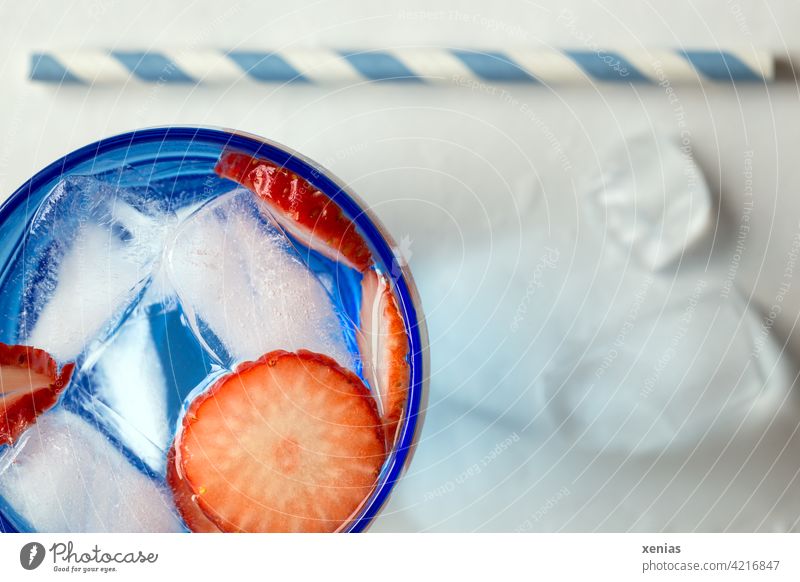 Aromatic fresh water with strawberry and ice cubes, drinking straw is ready Beverage Water Cold drink Ice cube fruit Fruit refreshingly Fresh Straw Blue Red
