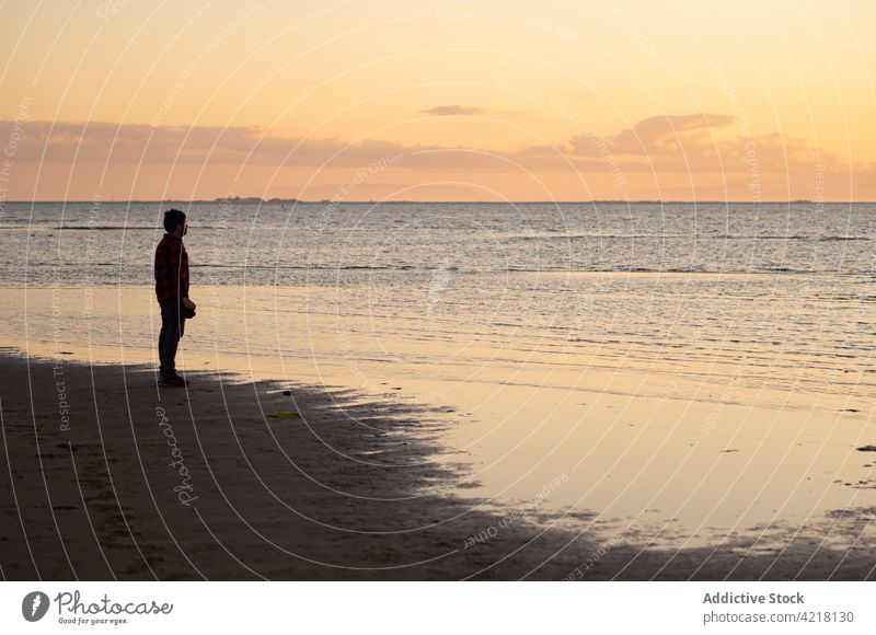 Traveler enjoying sunset on beach traveler man freedom sea photo camera silhouette happy take photo peace photographer nature male seashore contemplate