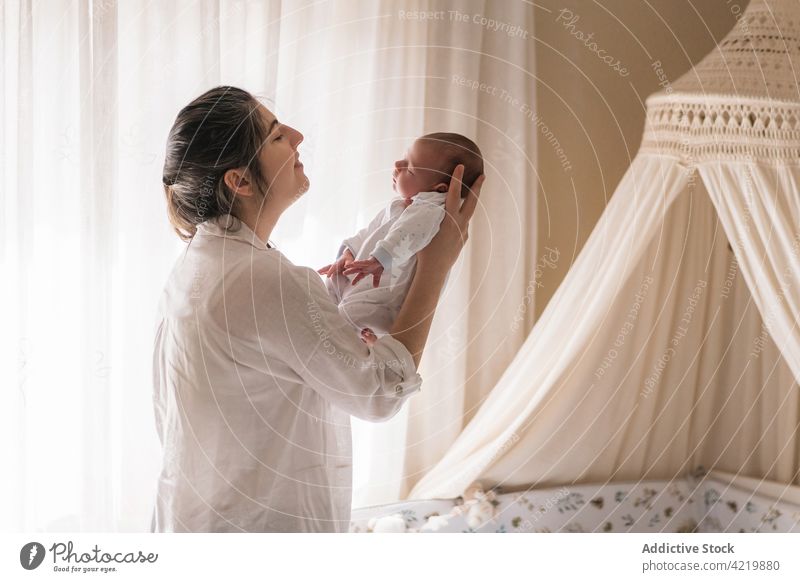 Mother breastfeeding little baby on bed - a Royalty Free Stock Photo from  Photocase