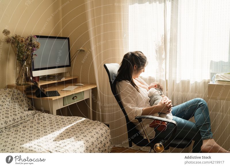 Mother breastfeeding little baby on bed - a Royalty Free Stock Photo from  Photocase