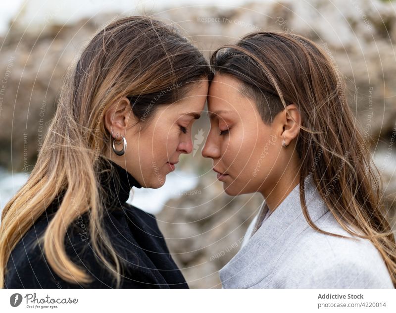 Couple of lesbian women touching foreheads couple face to face love relationship homosexual lgbt together fondness romantic touch forehead close eyes closed gay