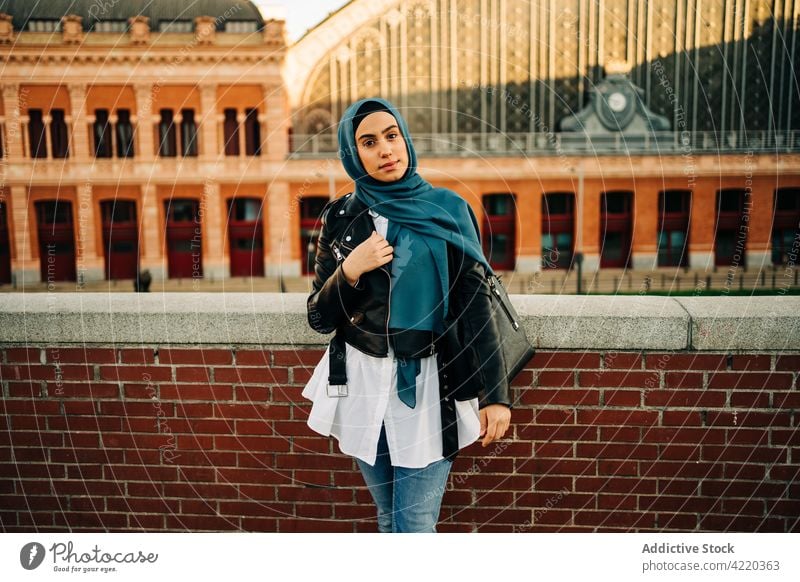 Stylish Muslim woman standing on street style hijab city charming headscarf trendy outfit smile female ethnic muslim tradition headwear headdress optimist glad