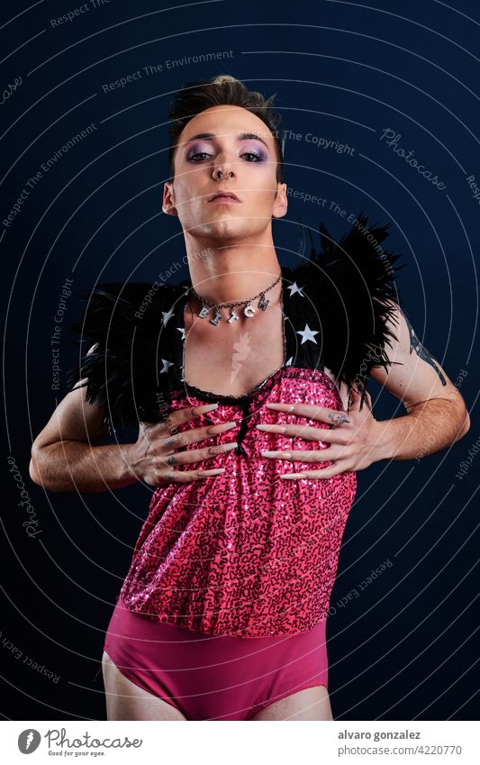 young transgender model with pink dress and dark blue background che homosexual diversity feminine portrait guy make-up male person caucasian isolated white