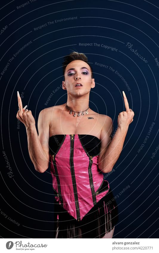 anger transgender young model making a flip off with middle finger portrait che guy make-up male person caucasian isolated white makeup gay face studio