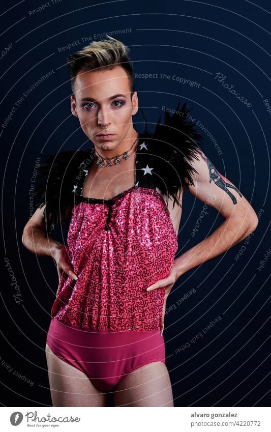 young transgender model with pink dress and dark blue background che homosexual diversity feminine portrait guy make-up male person caucasian isolated white