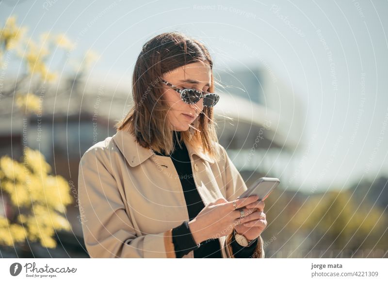 Portrait of a young businesswoman with her smart phone in lyon, france. person female caucasian europa lifestyle outdoors entrepreneur cyberspace freelancer