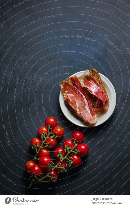 dish with Iberian ham with copy space for advertising toast serrano cured pork meat prosciutto toasted meal slice spanish tomato sliced iberian lunch tapas