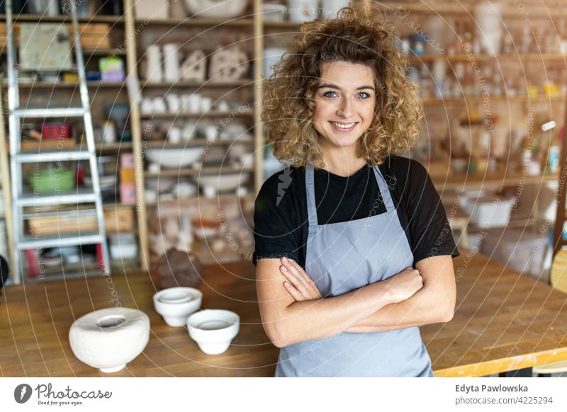 Portrait of woman pottery artist in art studio ceramics work working people young adult casual attractive female happy Caucasian enjoying one person beautiful