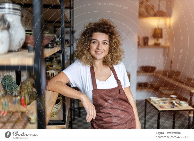 Portrait of woman pottery artist in art studio ceramics work working people young adult casual attractive female happy Caucasian enjoying one person beautiful