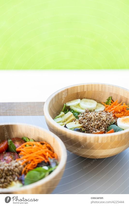 Brown rice salad with carrot, egg, cucumber, avocado, tomato and lamb's lettuce antioxidant asian background bowl brown buddha bowl copy space cuisine detox