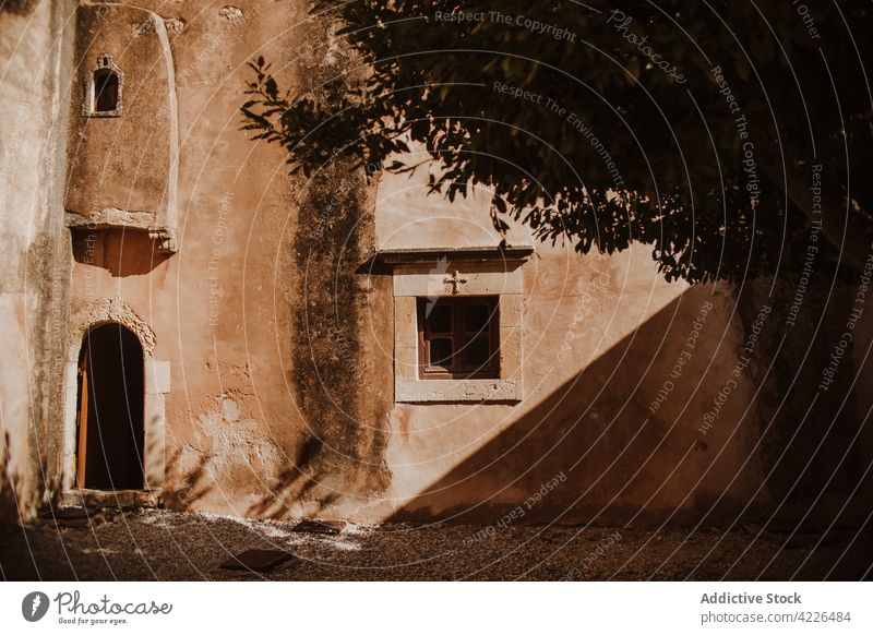 Medieval building wall with remaining windows and arched door architecture exterior historic heritage sightseeing medieval arkadi monasteri landmark crete