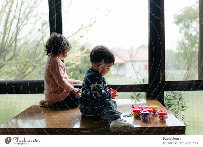 Brother and sister at window Brothers and sisters Child 1 - 3 years Caucasian Boy (child) Girl Window rainy Together Infancy Colour photo Human being Toddler