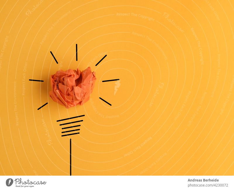 Crumpled paper ball as a lightbulb, conceptual business image for new ideas or creativity lamp energy drawing inspiration innovation power electricity bright
