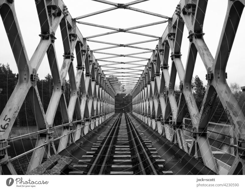 Bridge with dissolved supporting structures in grey tones truss bridge Architecture Sky railway line Railway bridge Railroad tracks Traffic infrastructure