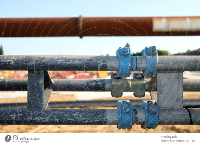 Tubes on a construction site conduit reeds Construction site Conduit Deserted nobody Industry technique Transmission lines Energy industry Water pipe metal pipe