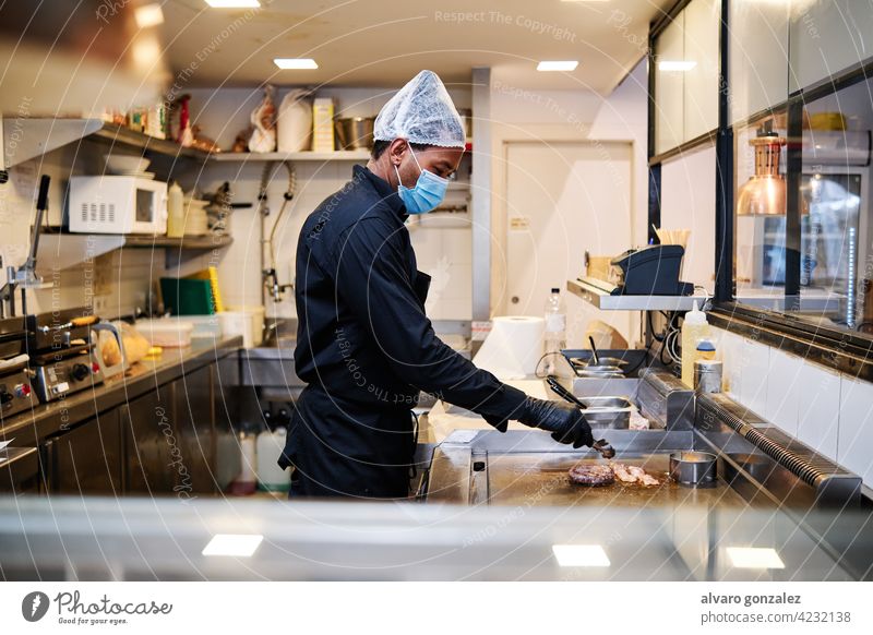 https://www.photocase.com/photos/4232138-close-up-of-professional-latin-chef-man-wearing-a-protective-mask-and-uniform-while-working-at-restaurant-kitchen-dot-photocase-stock-photo-large.jpeg